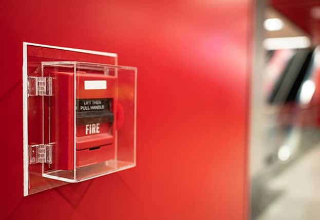 fire alarm system on a red wall