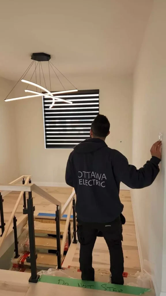 An Ottawa electrician fixes lights in the home.