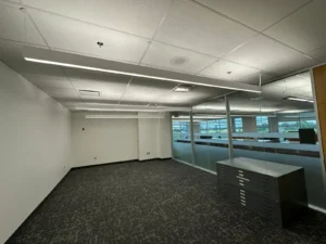 Carleton University MacOdrum Library archives area with suspended LED lighting, glass walls, and updated study space finishes.