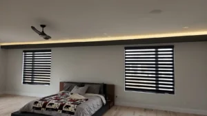 Custom Home in Greely bedroom with perimeter LED cove lighting, recessed lights, ceiling fan, and finished custom lighting.