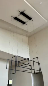 InHarmony Developments custom home with geometric pendant fixture, high ceiling, and recessed lighting.