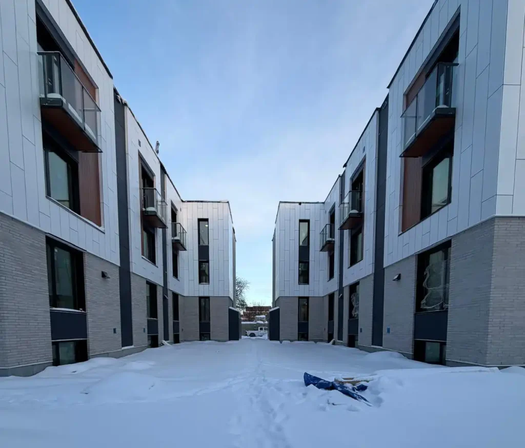 450 Booth Street Ottawa multi-unit electrical project showing completed stacked rental homes with a snow-covered courtyard.