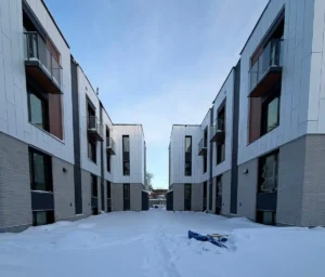 450 Booth Street Ottawa multi-unit electrical project showing completed stacked rental homes with a snow-covered courtyard.
