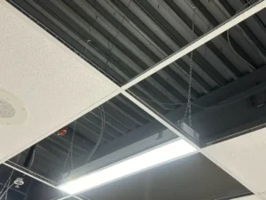 Carleton University MacOdrum Library ceiling work showing suspended LED fixture installation and open ceiling grid during renovation.