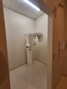 Dental & Plastic Surgery Facility X ray room with ceiling LED lighting, imaging equipment, and finished medical electrical fit up.