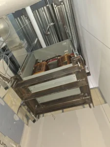 Dental & Plastic Surgery Facility ceiling mounted transformer installed on a custom steel support rack during medical fit up.