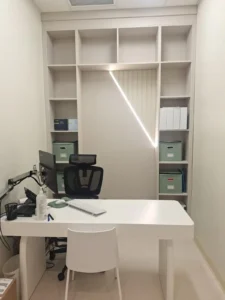 Dental & Plastic Surgery Facility consultation office with custom LED wall lighting, desk, shelving, and finished medical fit up.