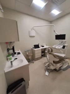 Dental & Plastic Surgery Facility dental operatory with LED ceiling lights, dental chair, sink, and finished clinical electrical fit up.