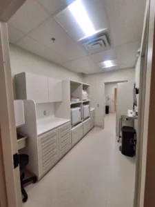 Dental & Plastic Surgery Facility sterilization room with LED ceiling lights, cabinetry, and finished medical electrical fit up.