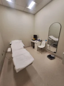 Dental & Plastic Surgery Facility treatment room with LED ceiling lighting, exam chair, workstation, and finished medical electrical fit up.