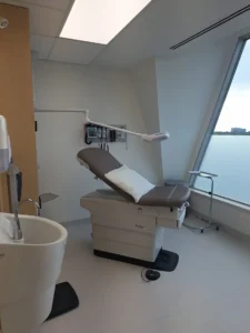 Ottawa Nurse Practitioner-Led Clinic exam room with LED ceiling panel lighting, medical equipment power, and finished electrical upgrades.