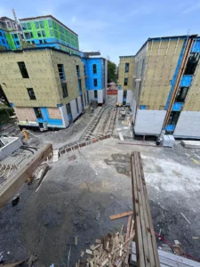 450 Booth Street construction phase showing stacked rental buildings, exterior sheathing, and active site work in Ottawa.