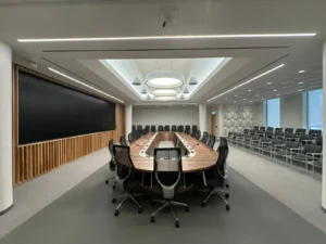 University of Ottawa Senate Room renovation showing pendant lights, linear ceiling lighting, and boardroom seating.