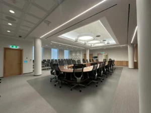 University of Ottawa Senate Room with linear ceiling lighting, circular pendant fixtures, and emergency lighting upgrades.