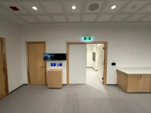 University of Ottawa Senate Room entrance with smart wall controls, exit lighting, and ceiling lights.