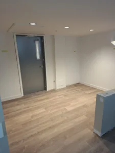 Windsor Park renovation room at Old Faulks Home with recessed lighting, new flooring, and electrical rough ins.