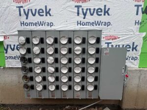 Exterior electrical meter bank and main disconnect installed for a multi unit residential building in Vanier, Ottawa.